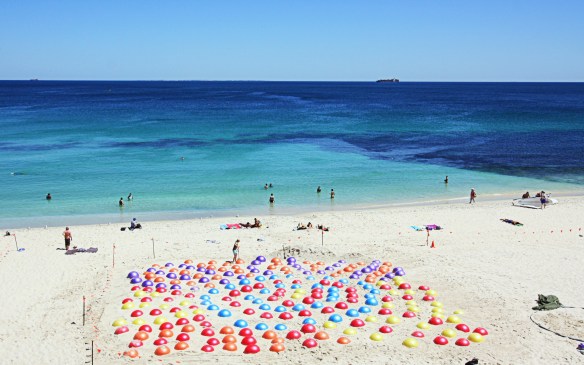 The finished work - a dot painting on the beach, against the backdrop of the Indian Ocean
